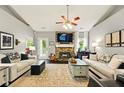 Bright living room featuring a stone fireplace, vaulted ceilings, neutral paint, and stylish furnishings at 827 Pinehurst Dr, Woodstock, GA 30188