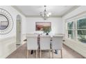 Elegant dining room with modern lighting and ample natural light at 891 Channel Dr, Lawrenceville, GA 30046