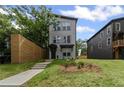 Inviting two-story home with modern architectural details and a well-maintained front lawn and wooden fence at 101 Fairfield Ct, Atlanta, GA 30314