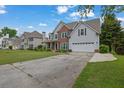 Inviting home with a spacious driveway and a beautifully landscaped front yard at 1663 Willow Way, Woodstock, GA 30188