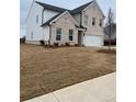 Charming two-story home showcasing a brick facade, a two-car garage, and a well manicured lawn at 1781 Jordan Brook Dr, Lawrenceville, GA 30043