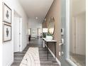Inviting hallway featuring wood floors, neutral walls, an oval mirror and tasteful decor at 1781 Jordan Brook Dr, Lawrenceville, GA 30043