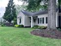Landscaped front yard of a charming home with lush green lawn and mature trees at 574 Chicasaw Ne Dr, Marietta, GA 30060