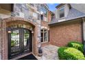 Close-up of the front entrance featuring a beautiful iron door, brick and stone architecture at 8340 Colonial Pl, Duluth, GA 30097