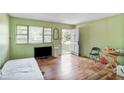 Living room with wood floor, a window, and an open door to the home's exterior at 2054 Fargo Se Pl, Atlanta, GA 30316
