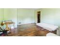 Spacious living room with wood floors, light green walls, and light streaming through an exterior window at 2054 Fargo Se Pl, Atlanta, GA 30316