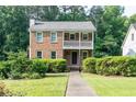 Charming brick home with a covered front porch and manicured landscaping at 3112 Calumet Nw Cir, Kennesaw, GA 30152