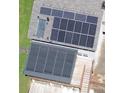 Aerial view of a roof showcasing solar panels and solar water heater, with a deck visible below at 3112 Calumet Nw Cir, Kennesaw, GA 30152