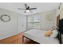Bright bedroom featuring hardwood floors, a ceiling fan, and neutral decor at 405 Branch Forest Way, Stockbridge, GA 30281