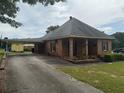 View of the home's exterior, including a covered carport and a long driveway leading to the residence at 871 Malcom Se St, Conyers, GA 30012