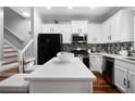 Modern kitchen features stainless steel appliances, white cabinetry, and quartz countertops at 1630 Marsanne Nw Ter # 27, Kennesaw, GA 30152