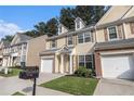 Welcoming townhouse boasts a well-kept lawn, attached garage, and appealing facade at 4139 Magnolia Glen Walk, Norcross, GA 30093