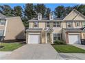 Inviting townhouse with a well-manicured lawn, attached garage, and classic design at 4139 Magnolia Glen Walk, Norcross, GA 30093