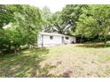 View of a spacious backyard with mature trees, offering privacy and a natural setting at 5904 Heatherwood Ln, Riverdale, GA 30296