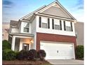 Two-story home boasts brick and siding exterior with an attached two car garage at 867 Crested Hawk Trl, Sugar Hill, GA 30518