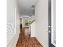 Inviting foyer featuring hardwood floors and views to living area with fireplace and outdoor scenery through bright windows at 867 Crested Hawk Trl, Sugar Hill, GA 30518