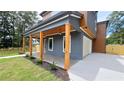 Stylish home featuring a covered porch with wood columns, integrated lighting, and an attached garage at 1197 Avondale Se Ave, Atlanta, GA 30312