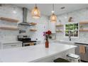 Updated kitchen with a quartz island, a modern range hood, and open shelving at 3285 Country Walk Dr, Powder Springs, GA 30127