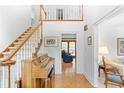 Grand foyer featuring hardwood floors, staircase, and natural light at 3472 Honeycomb Se Dr, Conyers, GA 30094