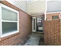 Charming brick entrance leading to the front door, offering a warm welcome with natural light from a window at 12 Dunwoody Springs Dr # 12, Atlanta, GA 30328