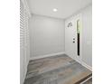 Bright foyer showcasing wood-look floors, white walls, and a door with a window, leading into the home at 12 Dunwoody Springs Dr # 12, Atlanta, GA 30328