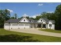 Charming home featuring a three-car garage, manicured lawn, and long driveway at 8 Ripplewood Trl, Euharlee, GA 30145