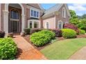 Beautiful brick home featuring a brick walkway and lush landscaping at 1200 Bay Pointe Terr Ter, Alpharetta, GA 30005