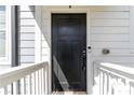 Exterior image of the front door featuring a black finish, smart lock, and traditional design at 1405 Attwater Dr, Atlanta, GA 30316