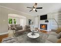 Cozy living room features a fireplace, hardwood floors, and plenty of natural light at 1849 Broad Ave, Atlanta, GA 30344