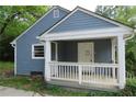 A quaint, single-story home featuring blue siding and a welcoming covered porch with white railing at 2172 Jernigan Drive Se, Atlanta, GA 30315