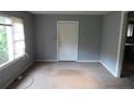 Empty living room featuring wood floors, a window, fresh paint, and a door to the outside at 2172 Jernigan Drive Se, Atlanta, GA 30315