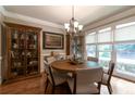 Formal dining room featuring hardwood floors, large windows, designer lighting and neutral paint at 2664 Long Pointe, Johns Creek, GA 30076