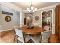 Elegant dining room with hardwood floors, chair rail detail, designer light fixture and warm paint at 2664 Long Pointe, Johns Creek, GA 30076