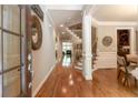Inviting entryway with hardwood floors, staircase, and views into the dining room and living spaces at 2664 Long Pointe, Johns Creek, GA 30076