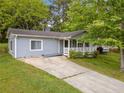 Charming single-story home with a well-maintained lawn and inviting front porch at 3428 Quail Sw Run, Marietta, GA 30008