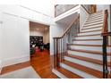 Elegant foyer with hardwood floors, staircase, and view into living space at 1000 Admiral Xing, Alpharetta, GA 30005