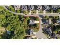 Aerial view showcases the home's location on a cul-de-sac with mature trees and landscaping at 1210 Magnolia Park Cir, Cumming, GA 30040