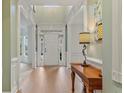 Bright foyer with hardwood floors, white trim, and a view to the front door at 1210 Magnolia Park Cir, Cumming, GA 30040