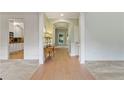 Hallway featuring hardwood floors, table with lamp, and view to the kitchen at 1210 Magnolia Park Cir, Cumming, GA 30040