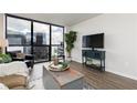 Cozy living room with expansive window views offering great natural light and modern finishes at 1280 W Peachtree Nw St # 3602, Atlanta, GA 30309