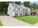 Inviting two-story home with a lush green lawn and a spacious driveway leading to the attached garage at 336 Parc Xing, Acworth, GA 30102