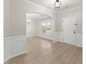 Inviting living room with a large window, modern light fixture, and updated flooring at 336 Parc Xing, Acworth, GA 30102