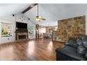 Spacious living room features hardwood floors, stone accents, and a cozy fireplace at 966 Crest Ridge Sw Dr, Marietta, GA 30060
