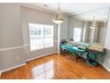Spacious dining room with beautiful wood floors, a large window, stylish light fixture, and a mirrored wall at 1731 Pryor Sw Rd # 109, Atlanta, GA 30315