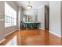 Bright dining room with hardwood floors, large window, modern light fixture, and a large mirrored wall at 1731 Pryor Sw Rd # 109, Atlanta, GA 30315