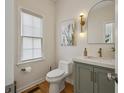Stylish powder room featuring modern fixtures, arched mirror, and an artistic cactus print at 4735 Cambridge Trce, Atlanta, GA 30338