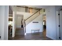 Inviting foyer featuring a staircase with white railings, wood floors, and an open view to the second story at 760 King Sword Ct, Mableton, GA 30126