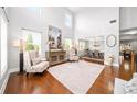 Elegant living room with soaring ceilings, hardwood floors, and abundant natural light at 149 Manor Ln, Woodstock, GA 30188