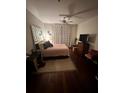 Cozy bedroom with neutral tones, hardwood floors, and a ceiling fan for comfortable living at 200 Renaissance Ne Pkwy # 305, Atlanta, GA 30308