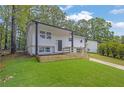 An inviting home with clean lines, complemented by lush green grass at 2184 Cherokee Valley Cir, Lithonia, GA 30058